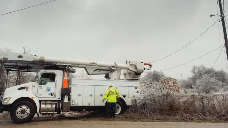 FILE- Crews from Pedernales Electric Company work to repair downed power lines in Buda on...