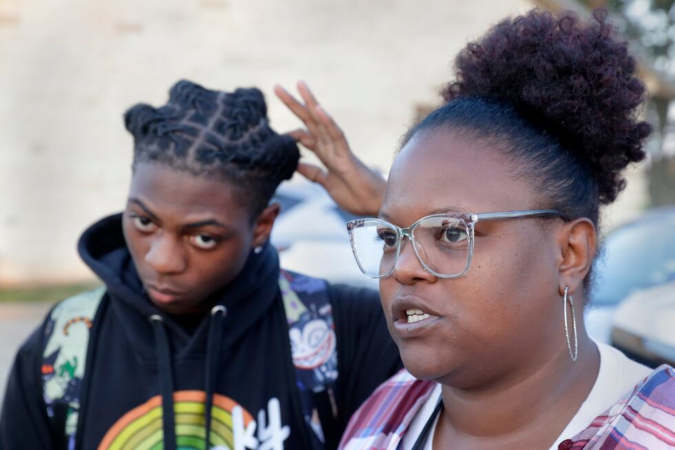 Darryl George, left, a 17-year-old junior, and his mother Darresha George, right, talks with...