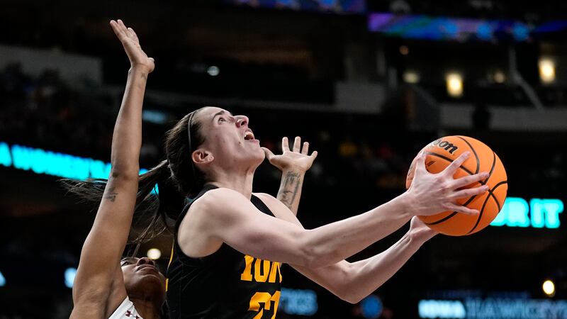 Iowa's Caitlin Clark shoots past South Carolina's Kierra Fletcher during the second half of an...