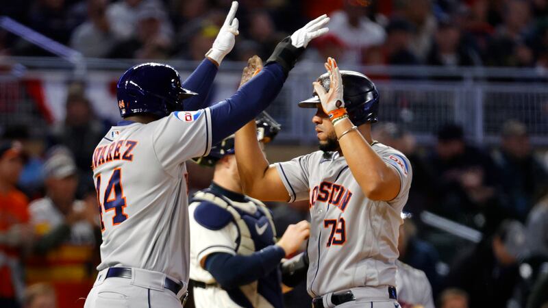 Houston Astros' Jose Abreu (79) is greeted at home plate by Yordan Alvarez after they scored...