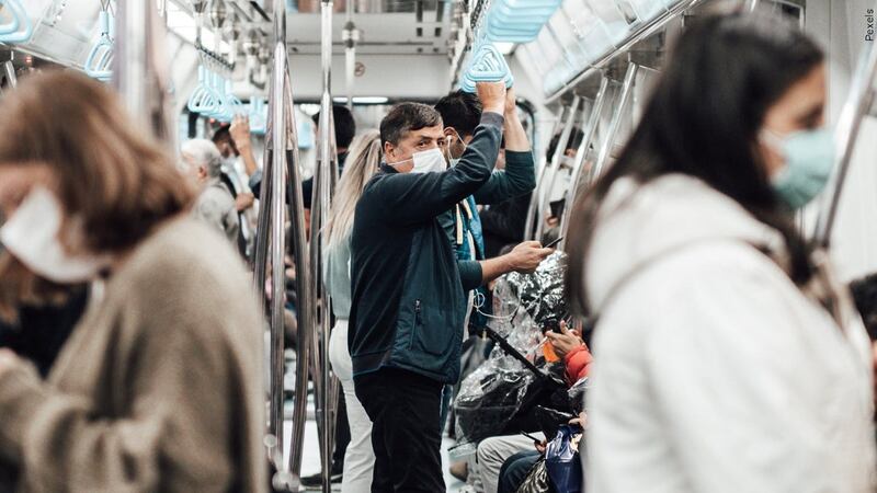 FILE: Passengers wear masks while riding on public transportation. The World Health...