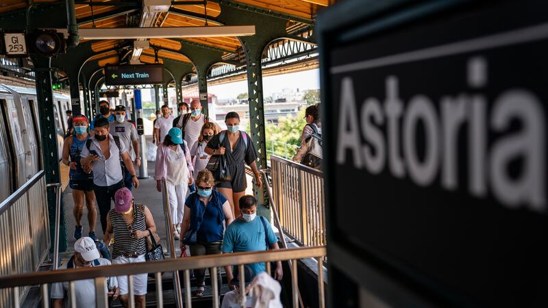 FILE - Passengers exit the Astoria-Ditmars Boulevard subway station in the Queens borough of...