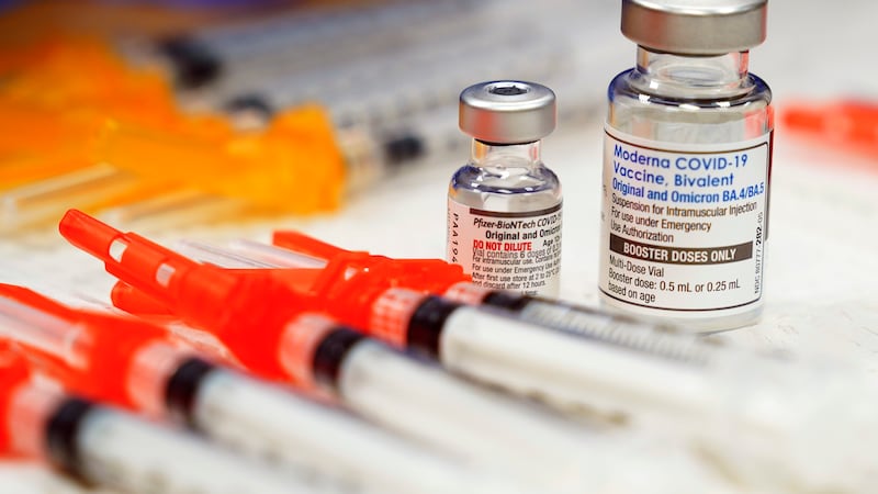 FILE - Pfizer, left, and Moderna bivalent COVID-19 vaccines are readied for use at a clinic,...