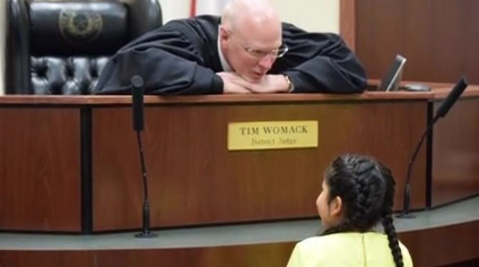 Judge Tim Womack speaking with a child in court. (Source: KLTV)