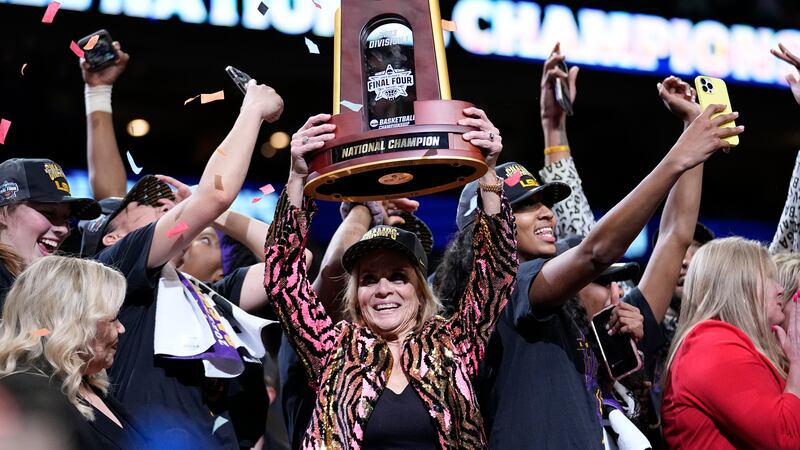 LSU head coach Kim Mulkey holds the winning trophy after the NCAA Women's Final Four...