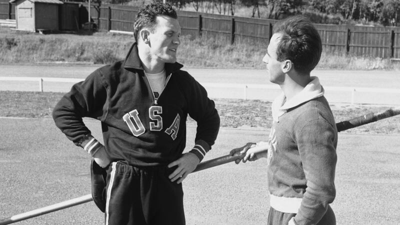 FILE - American pole vaulter Bob Richards, left, talks with Brazilian pole vaulter Helcio...