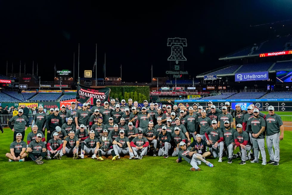 The Arizona Diamondbacks pose after their win against the Philadelphia Phillies in Game 7 of...