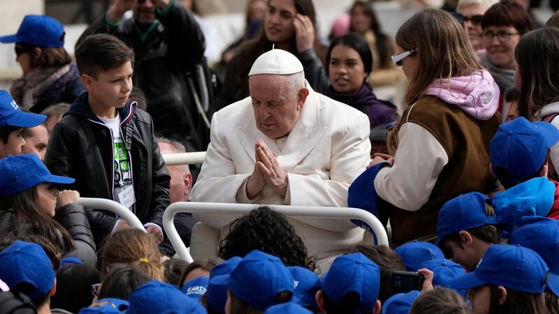 FILE - Pope Francis meets children at the end of his weekly general audience in St. Peter's...