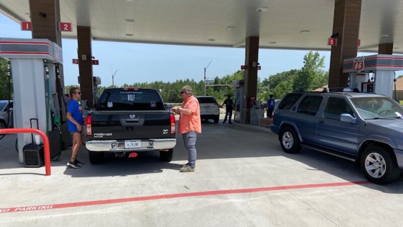 People filling up gas tanks