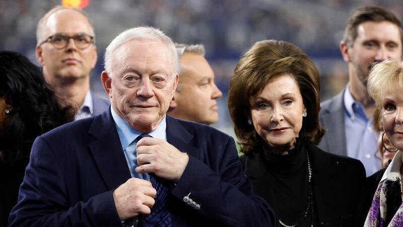 FILE - Dallas Cowboys owner Jerry Jones and his wife Gene Jones, right, stand on the field...
