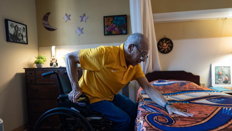 Alex Morisey lifts himself out of his wheelchair in his room at a nursing home in...