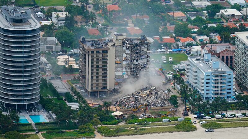 FILE - Rescue personnel work in the rubble at the Champlain Towers South Condo, Friday, June...