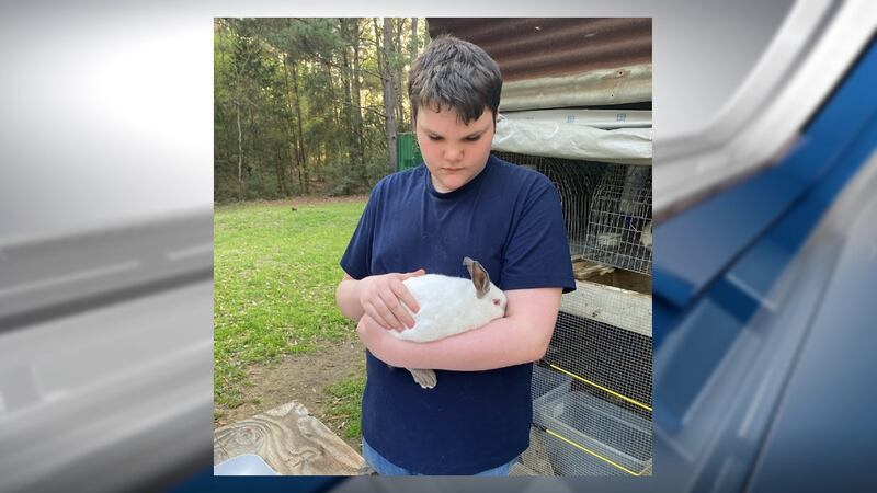 Zane Fuller holds a rabbit he will present in a competition at the Angelina County Fair.