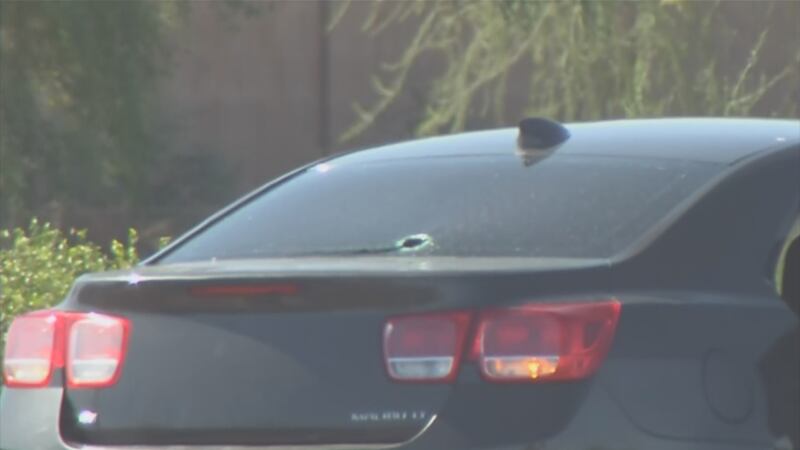 A black car involved in a road rage incident is shown with a bullet hole in the glass. An...