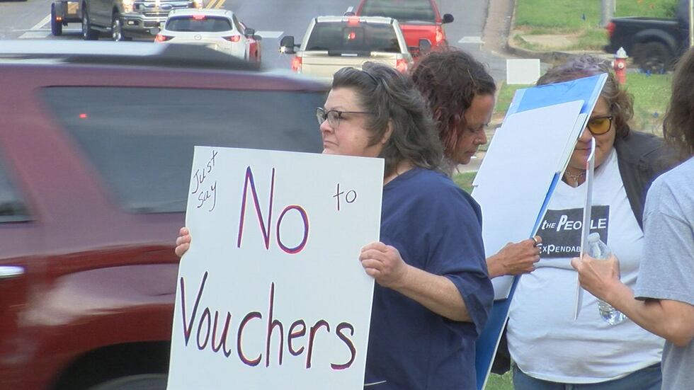 A former principal and grandmother of students in public school protests the governor's plan.