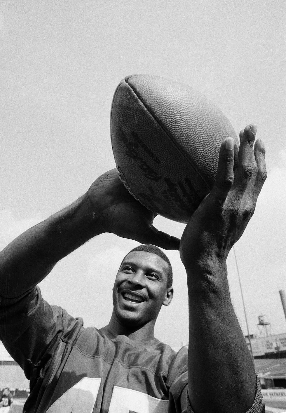 New York Giants end Homer Jones wraps his big hands around a football during workout at New...