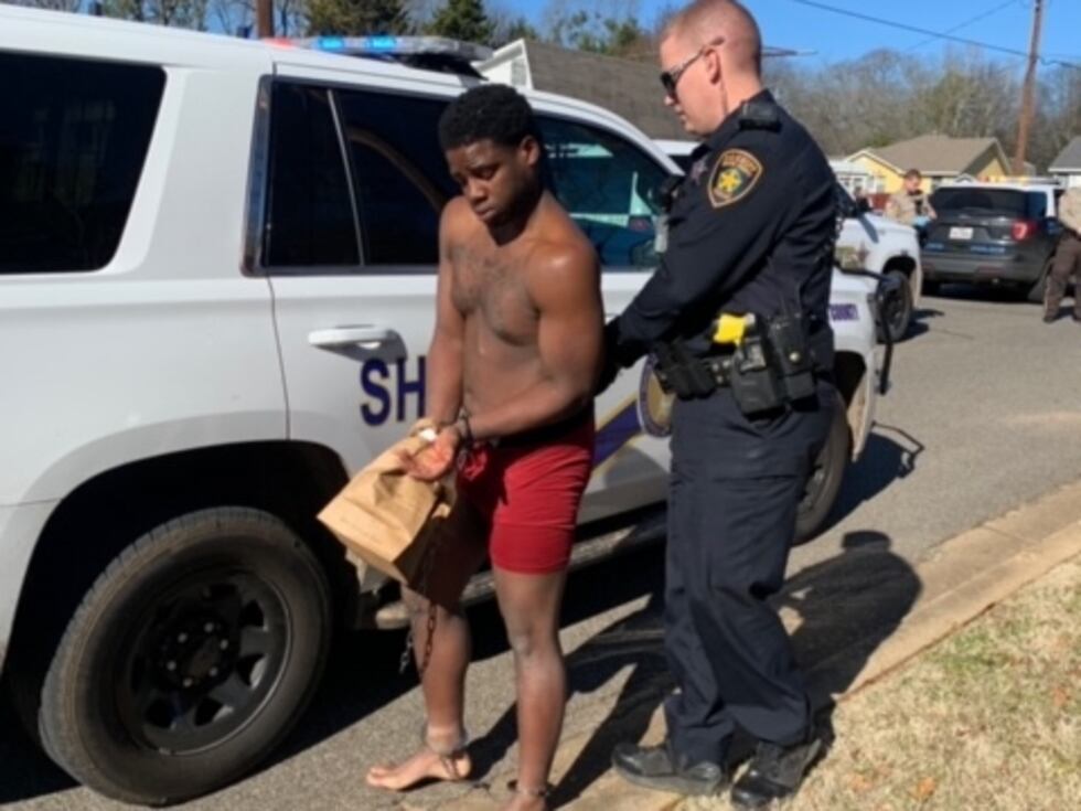 Mytrez Deunte Woolen, 21, of Arlington, is seen being taken into custody by a deputy with the...
